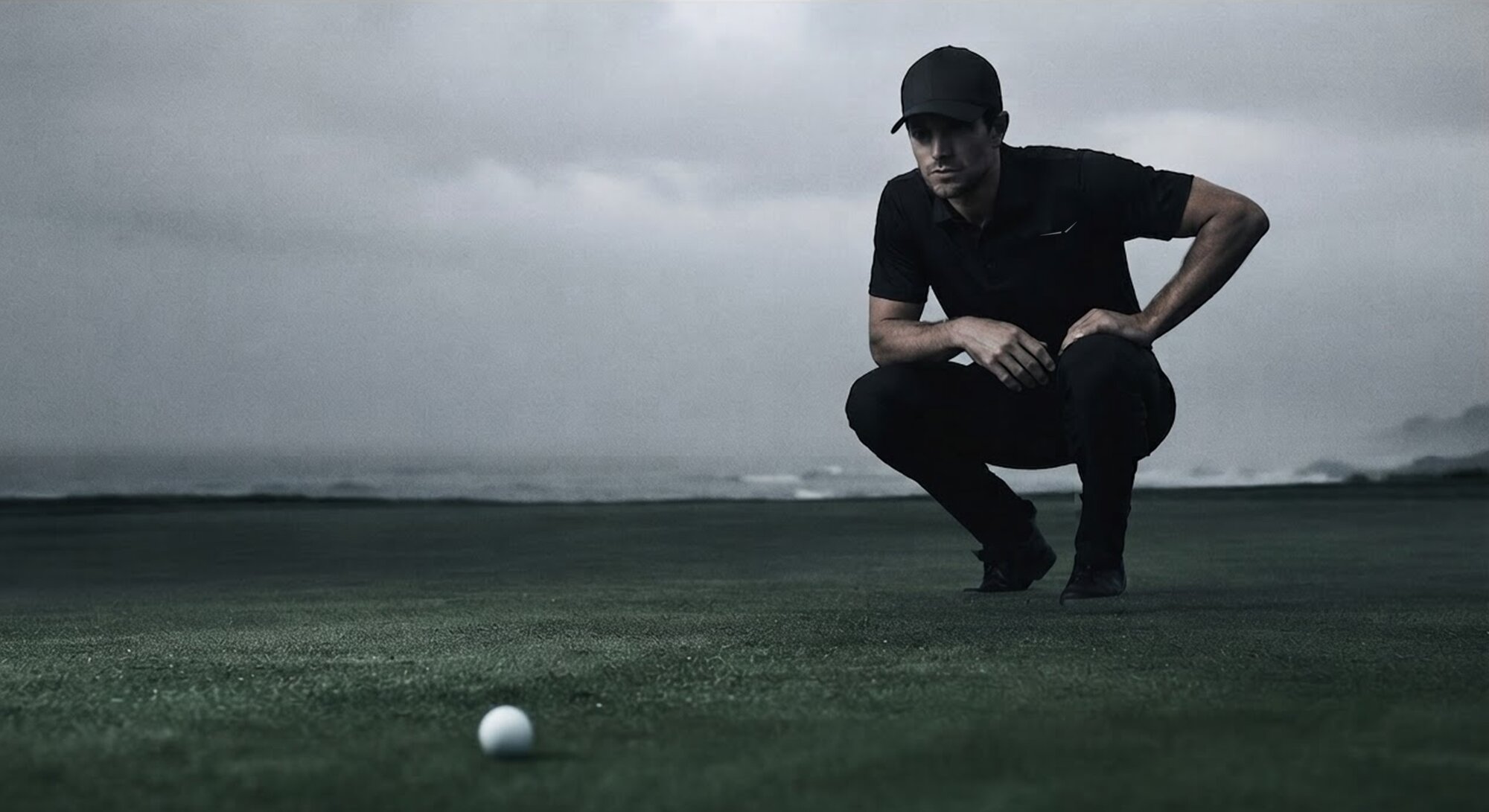 Player reading a putt in wet conditions